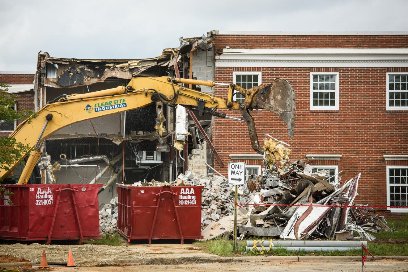 A building is torn down to make way for more parking at Cape Fear Valley Medical Center on Thursday, July 25, 2024