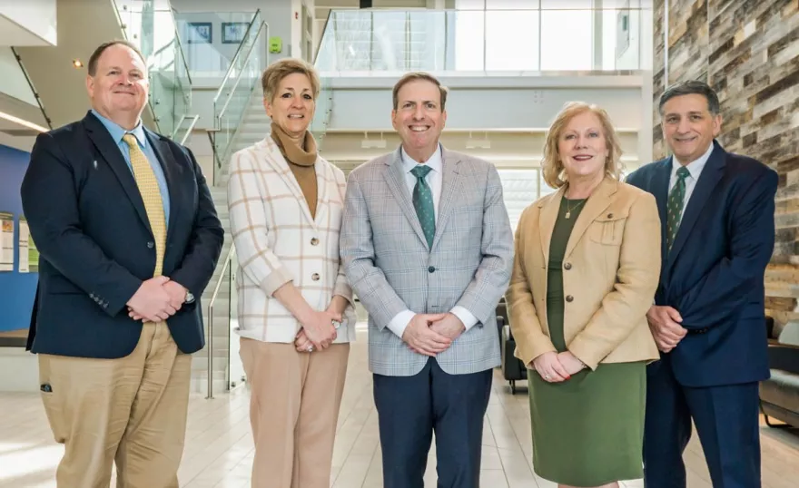 The Methodist University Cape Fear Valley Health School of Medicine senior leadership team stands in Methodist University's McLean Health Sciences Building (left to right): Scott Bullard (Chief of Staff), Dr. Stephanie Mann (Senior Associate Dean for Academic Affairs), Dr. Hershey Bell (Founding Dean), Dr. Kimberly Vess (Senior Associate Dean for Student Experience), and John Worth (Senior Associate Dean for Administration and Finance). Photo provided by: Methodist University.