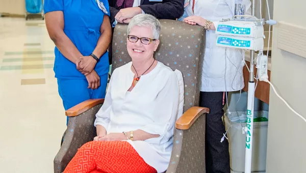 patient smiling with their care team