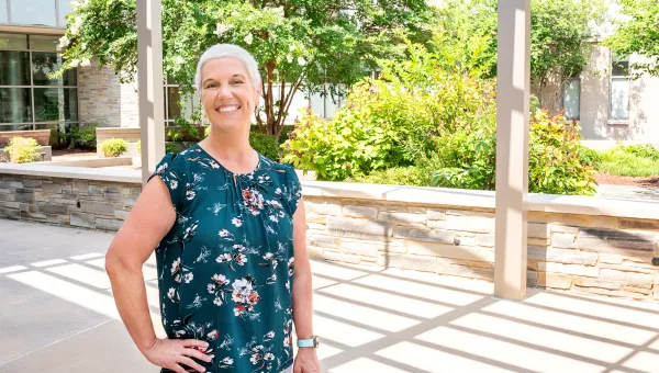 patient smiling outside of cancer center