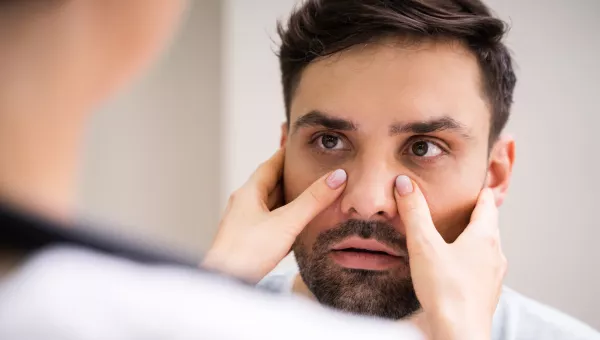 Doctor examining a man's sinuses