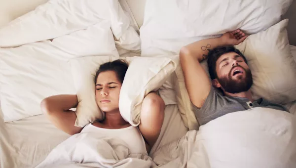 Man snoring and keeping his partner from sleeping