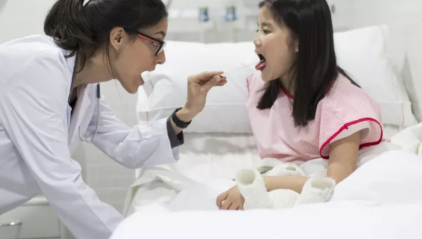 Otolaryngologist examining a young patient