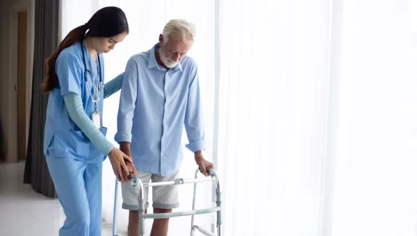 Nurse helping patient with rehabilitation