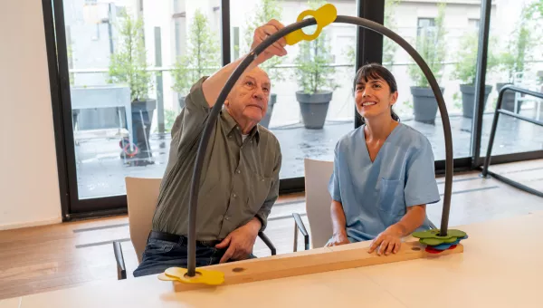 Physical therapist helping patient