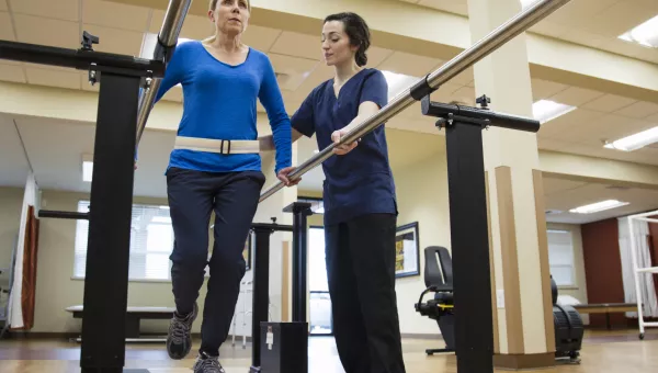 Physical therapist helping patient