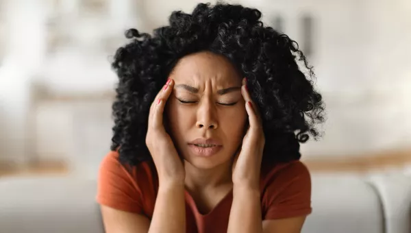 woman showing signs of a headache