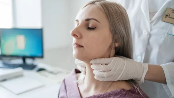 woman getting checked to see if Thyroid Surgery is needed