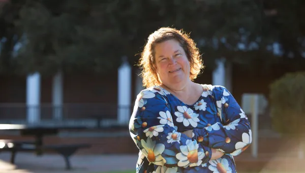 heart and vascular patient smiling in a grassy outdoor area