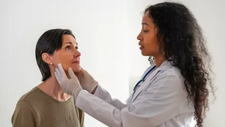 Doctor examining patients tonsils