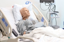 A mannequin patient in a Simulation Center bed