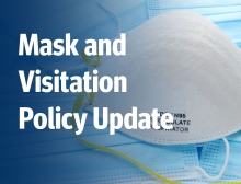 White text on the background image of a hospital mask. Text reads: Mask and Visitation Policy Update.